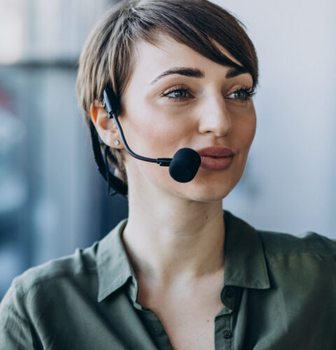 Young woman with microphone working on record studio